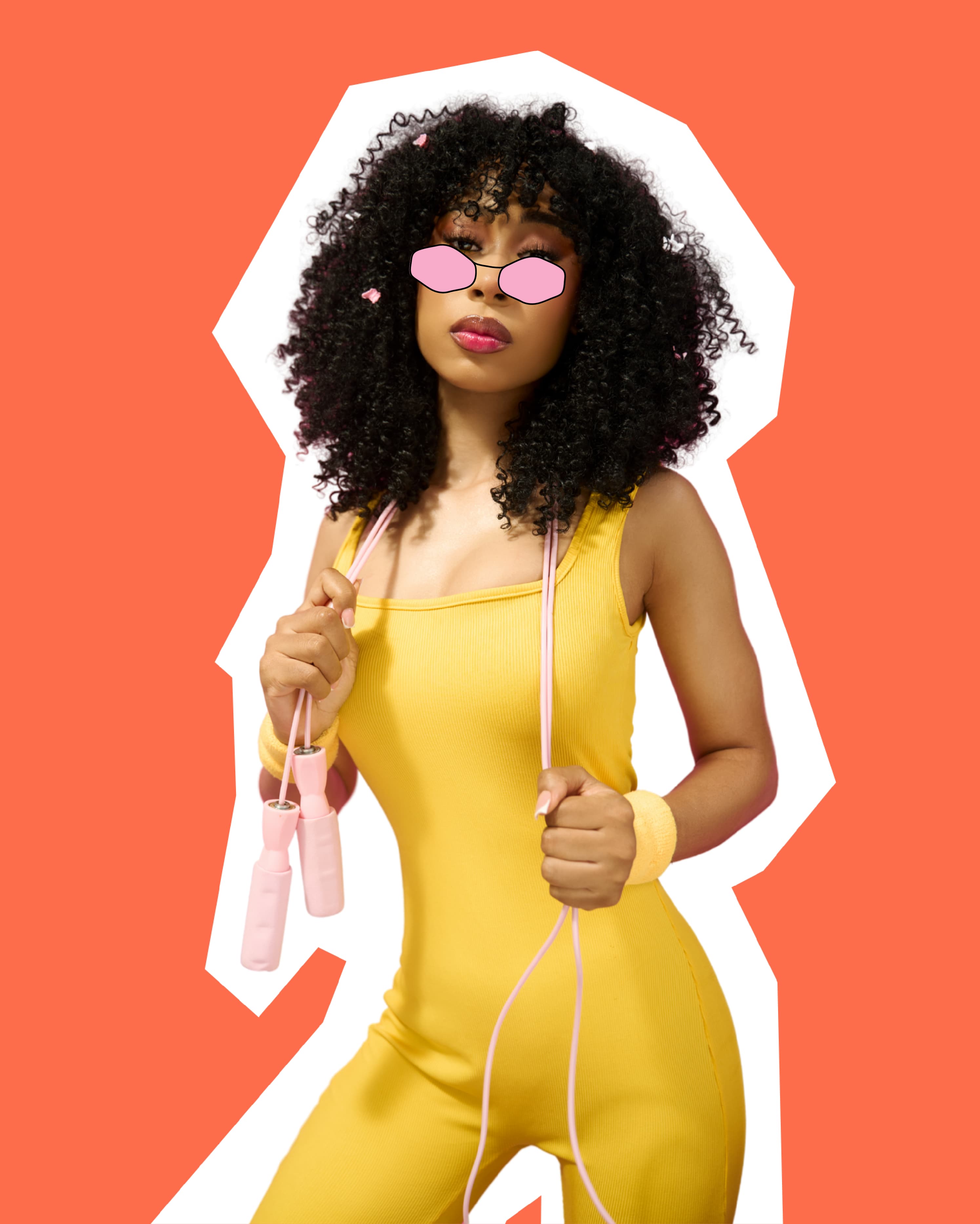 cut out of a model wearing the diva wig. she is in a yellow workout outfit and has a pink jumprope around her neck