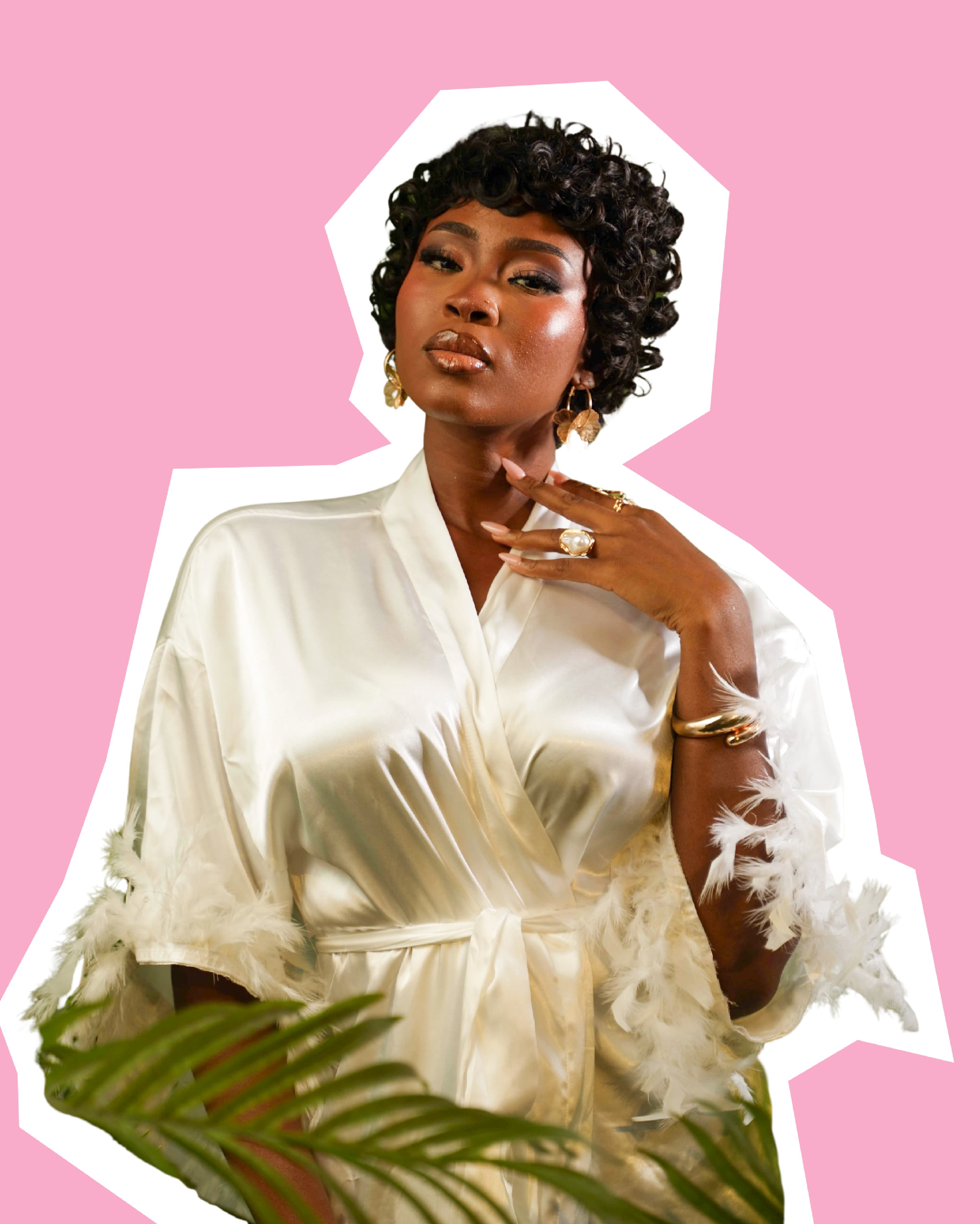 cut out of a woman in a white silk robe wearing the muse pixie wig against a pink backdrop